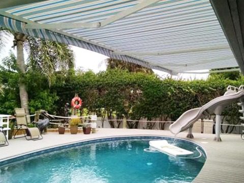 An awning provides poolside shade in the Southeast