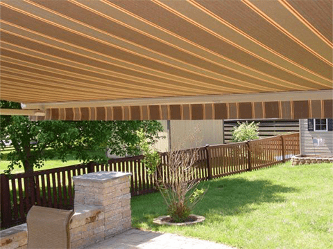 The backyard of a Southwestern home is shaded with a state-of-the-art Sunesta awning