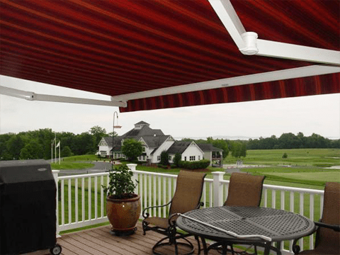A Sunesta awning is extended over the patio of a Midwestern home