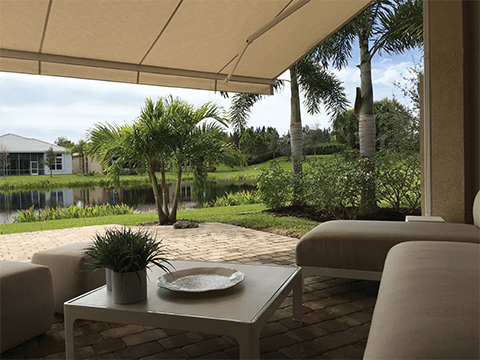A residential patio in the Southeast is shaded by a Sunesta awning with revolutionary technology