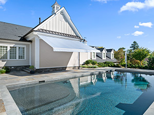 A Sunesta awning extends out over a residential patio in the Southwest